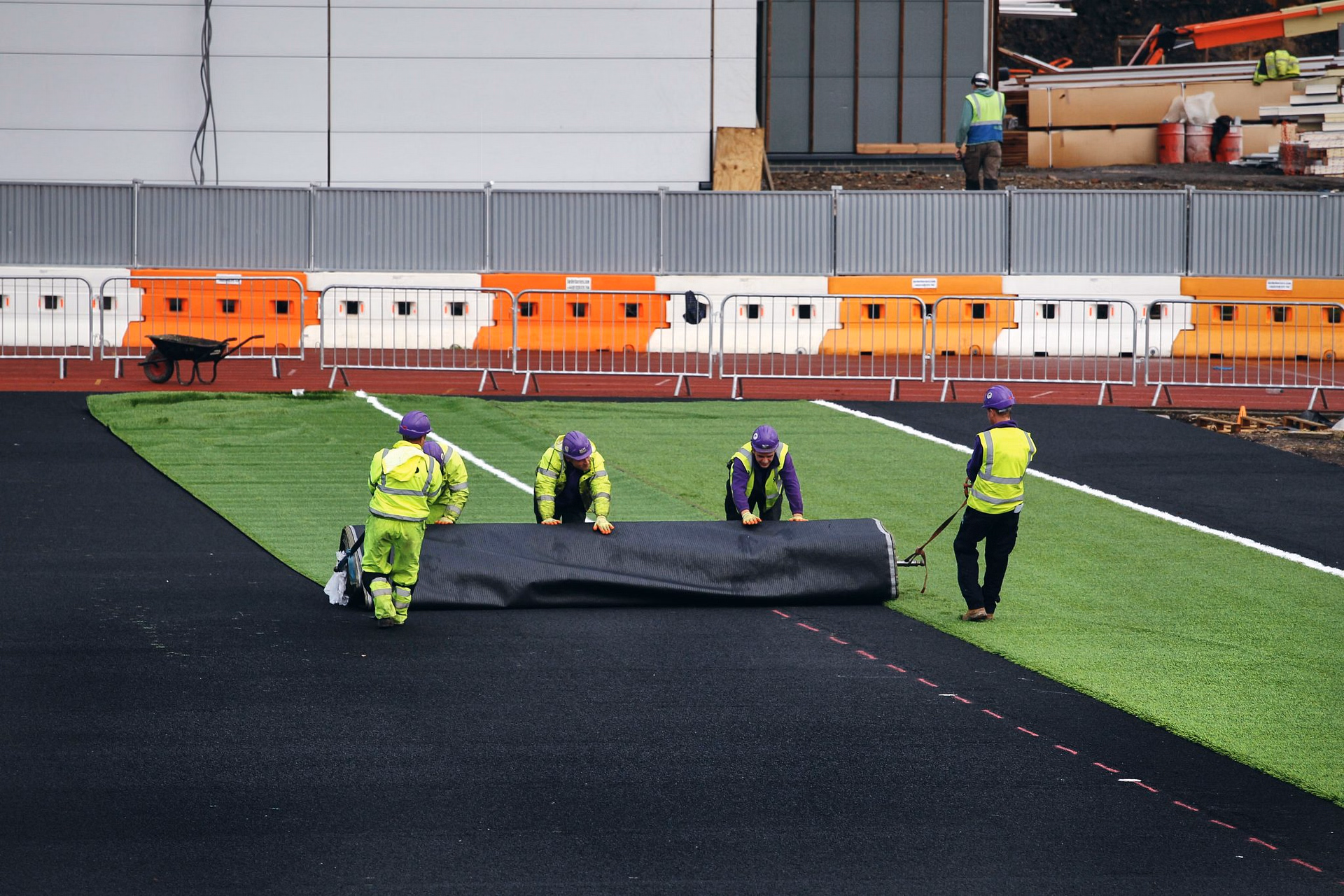 sis pitches staff installing synthetic turf